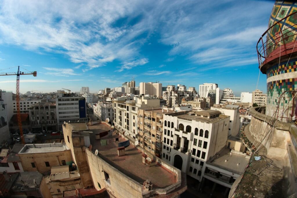 Aerial view of Casablanca's downtown skyline with dense residential and commercial buildings under blue sky.